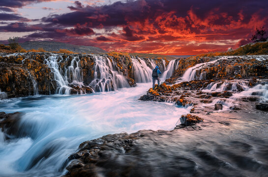 Scenic image of Iceland. Fantastic colorful sunset over the Bruarfoss Waterfall with picturesque sky. Wonderful Nature landscape. Iceland popular place of travel and touristic location.