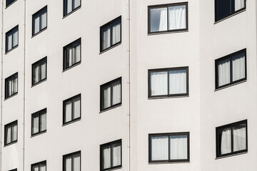Tall multi-storey building with identical windows.