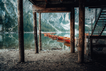 Fototapeta na wymiar Boats on the Braies Lake Pragser Wildsee in Dolomites mountains, Sudtirol, Italy