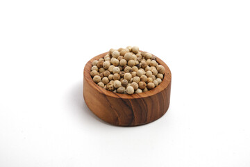 white peppers in wooden bowl isolated on white