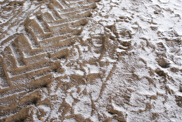 Tire track in sand with snow. Offroad track of car.

