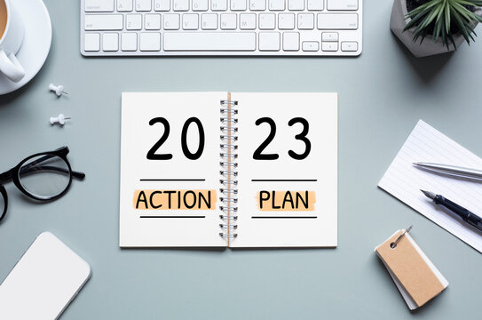 2023, new year action plan concepts with text on notepad and office accessories.
