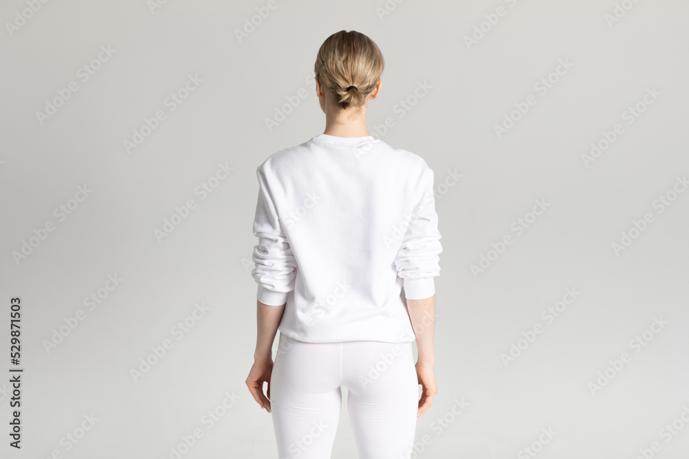 Poster Attractive blonde woman in white sweatshirt and leggings on white background. Mock-up.