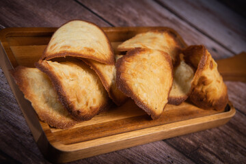 French delicacy pastry tuile with almond on wood background, High quality photo