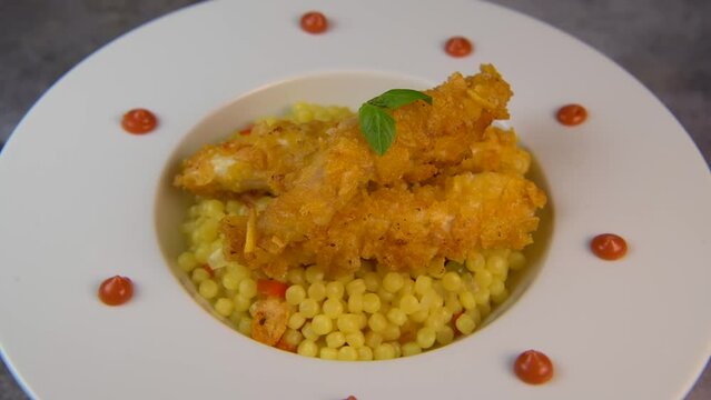 Recipe for chicken tenders with corn flakes and Italian Piombo pasta risotto and peppers. High quality video