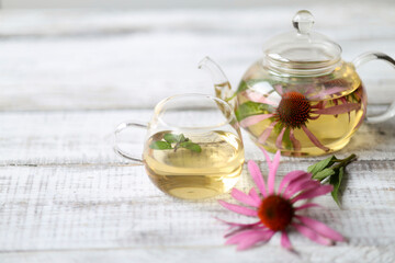 Cup of herbal tea from echinacea and mint used in alternative medicine a an immune system booster. - obrazy, fototapety, plakaty
