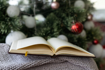 Christmas background with blank notebook, fir branches, decorations and gift boxes. Space for text. Top view. Christmas to-do list or wish list