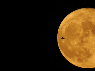 Full moon with plane
