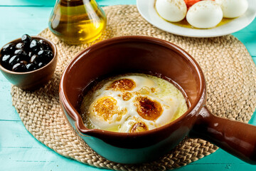 Eggs Sunny Side Up served in dish isolated on wooden table side view of middle eastern food