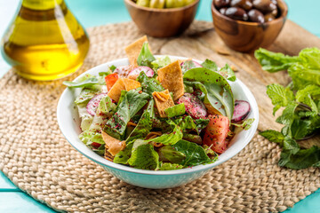 Fattoush served in dish isolated on wooden table side view of middle eastern food