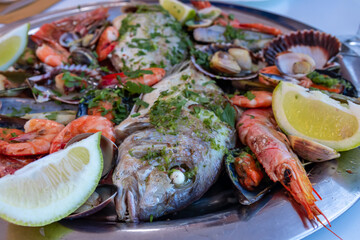 Mixed plate of seafood and fish served in a local restaurant in Puerto de la Cruz, Tenerife, Canary Islands, Spain, Europe. Healthy Mediterranean food during vacation