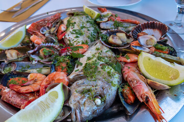 Mixed plate of seafood and fish served in a local restaurant in Puerto de la Cruz, Tenerife, Canary Islands, Spain, Europe. Healthy Mediterranean food during vacation