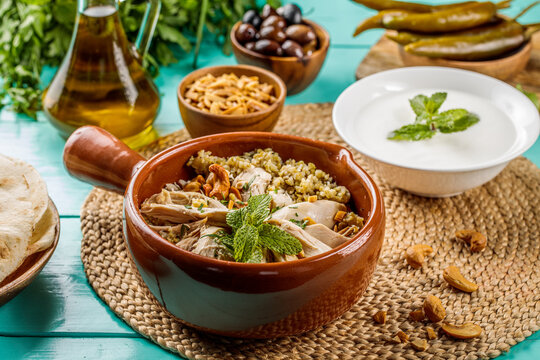 Freekeh Chicken or Freekat Chicken served in dish isolated on wooden table side view of middle eastern food
