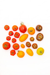Assorted tomatoes on a white background . Tomatoes copyspace . Homemade vegetables .