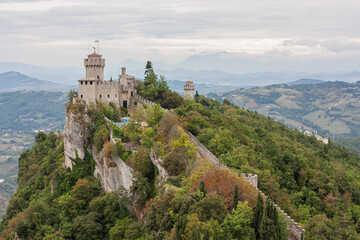Fototapeta na wymiar View of the Guaita Fortress on Mount Titano in San Marino. Tower on a cliff over 800 meters high in an independent state in the heart of Italy