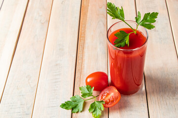 Diet tomato juice with parsley on wooden background. Vegan vegetable smoothie.