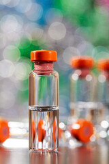 Close-up of medicine for injection in glass vials on a colorful background