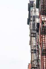 Old New York apartment building with fancy terra cotta detailing Manhattan Lower East Side apartment building with external fire ladders