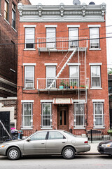 Fototapeta na wymiar Old New York apartment building with fancy terra cotta detailing Manhattan Lower East Side apartment building with external fire ladders