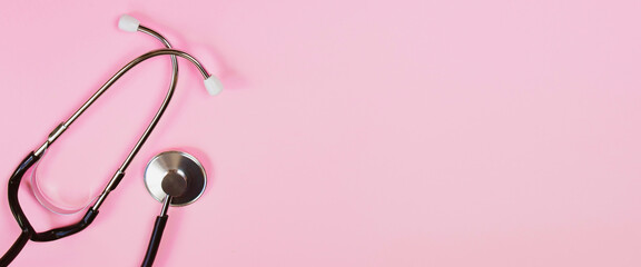 Stethoscope on pink background. Health care concept. Medical instrument for diagnosing diseases.