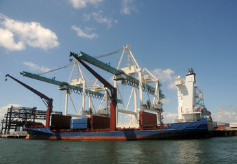 Cargo ship loading in industrial port - 529888172