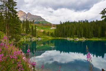 view of lake of carezza in summer in a cloudy day