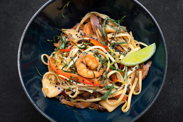 Spaghetti with seafood on a dark background