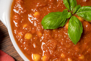 Close-up of chickpea curry cooked Indian style with tomatoes, onions and spices. Served in a bowl. A healthy vegetarian dish.