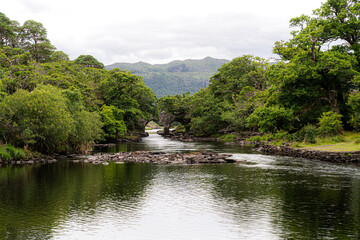 Obraz premium Meeting of the Waters, Killarney. the best hidden gem. This is the point where all of Killarney’s three glorious lakes merge together, the upper lake, Muckross Lake and Lough Leane. Old Weir Bridge.