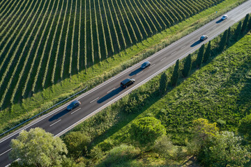 The movement of cars in motion blur on the motorway top view. Beautiful car road diagonally between...