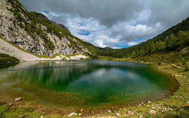 Beautiful panorama view of Schwarzensee lake near Tauplitzalm in Ausseerland region on a sunny summer day with blue sky cloud, Styria, Austria - 529893189