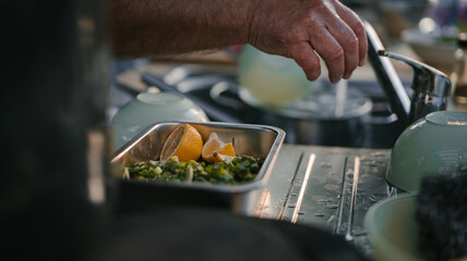 Close up photo of male hands is preparing wonderful fresh salad. Chef cooking food cutting prepare hands knife preparing vegetables.