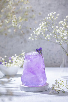 Lavender Gin and Tonic Punch Cocktail. Elegant glass filled with violet cocktail or mocktails