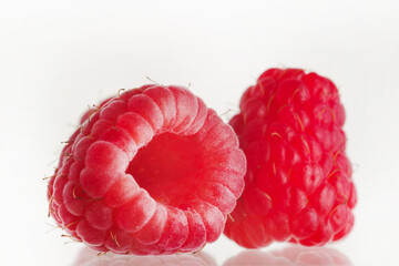 Macro shot. Ripe raspberries on a white background. Delicious sweet food, vitamins, antioxidant. Juice, jams, confectionery stuffing. Healthy lifestyle. - Powered by Adobe