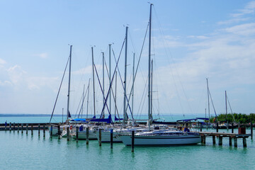 Fototapeta na wymiar Docking of a sailboat in the harbor on a beautiful sunny day - Balaton lake marina