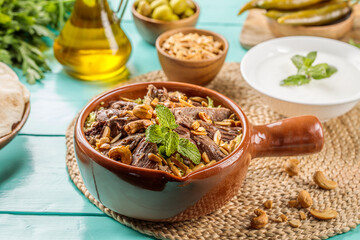 Kharoof Mahshi with nuts served in a dish isolated on wooden table side view of middle eastern food
