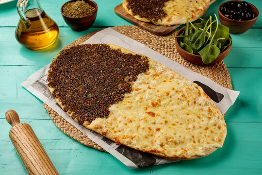 Half Zataar Half Cheese Mashrooha pizza served in a dish isolated on wooden table side view of middle eastern food