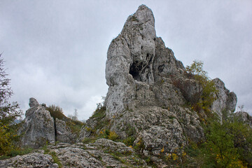 landscape with a rock against a cloudy sky