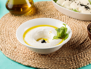 Lebneh or Lebnah served in a dish isolated on wooden table side view of middle eastern food