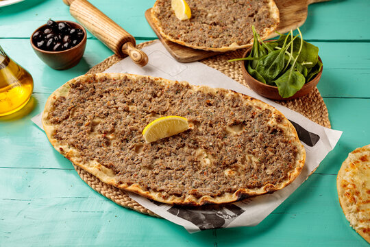 Laham Beajin Mashrooha served in a dish isolated on wooden table side view of middle eastern food