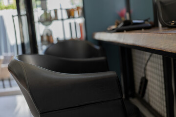 black barber chair in front of the mirror