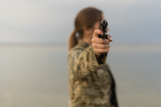 military woman with a weapon in hand