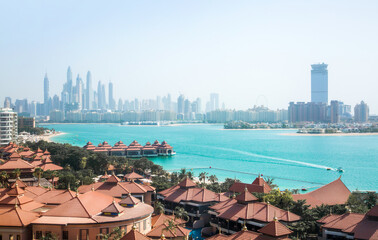Dubai, The Palm. Roofs of holidays villas and Dubai Marina skyscrapers at the background. Panoramic...