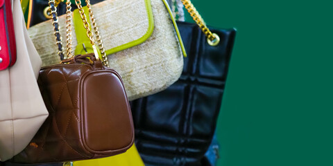 Vintage handbags on green background, panoramic view. Weekend flea market, second hand