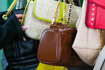Woman chooses vintage handbag in second hand. Weekend flea market