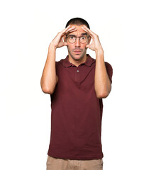 Naklejka premium Depressed young man posing against background