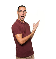 Fototapeta premium Amazed young man making a gesture of welcome
