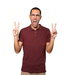 Naklejka premium Happy young man making a victory gesture with his fingers