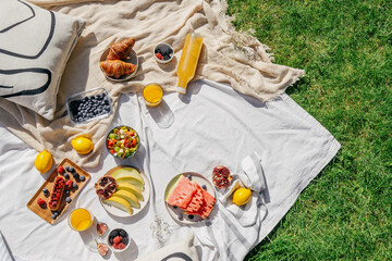 picnic on blanket with food at summer sunny day - obrazy, fototapety, plakaty