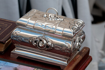 A decorative, silver storage container used to hold an etrog or citron fruit, one of the four...